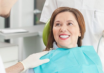 Older woman in dental chair smiling