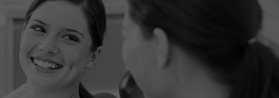 Smiling woman in dental chair black and white