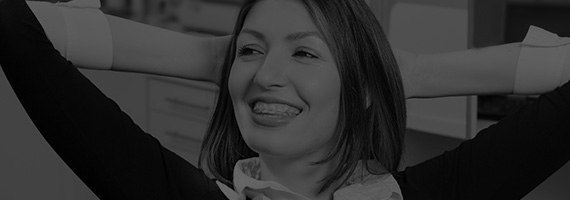 Relaxed woman in dental chair black and white