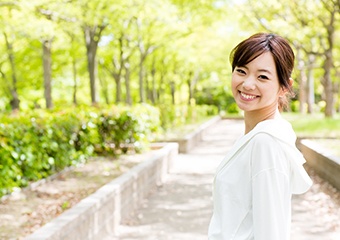 person walking outside and smiling