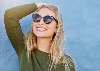 woman smiling brightly after seeing her cosmetic dentist in Columbia 