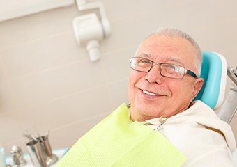 Older man smiling in dental chair