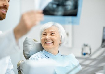 Denture dentist in Columbia explaining X-ray to patient