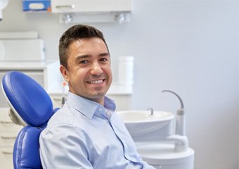 Man with light blue shirt visiting emergency dentist in Columbia, TN