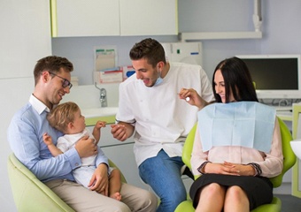 dentist treating little boy and his mother 