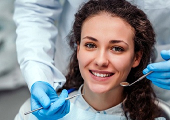 woman with curly hair at dental checkup 