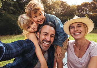 family of four sitting in the grass 