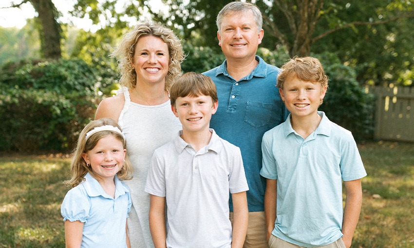 Dr. Goodman's family smiling at a park