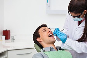 A dentist examining a patient
