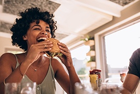 Patient in Columbia eating with dental implants
