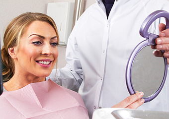 Woman looking at smile in mirror