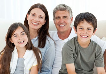 Smiling mother father and two children