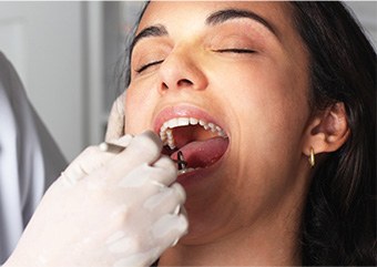 Woman receiving oral cancer screening