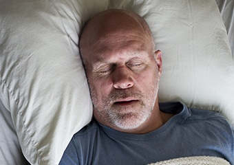 Man sleeping soundly in bed