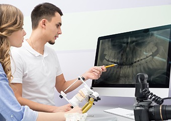 Dentists looking at digital dental x-rays