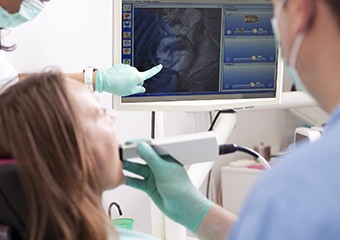 Dentist and patient looking at intraoral photos