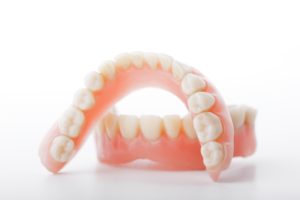 Upper and lower dentures in Columbia on table.