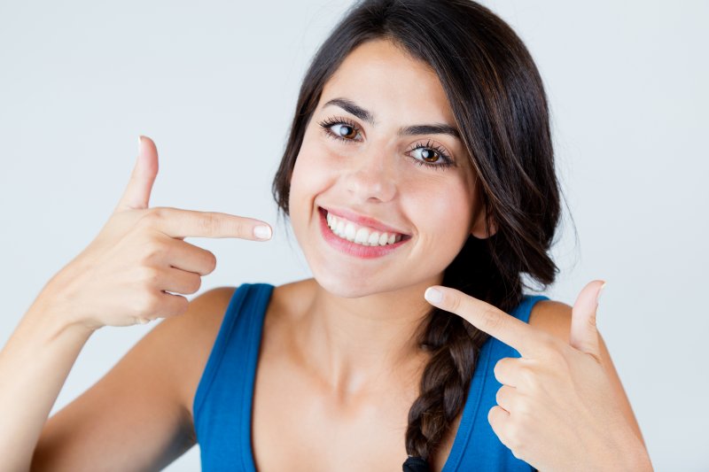 girl pointing to her smile