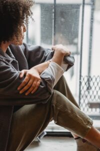 Depressed woman looking out a window